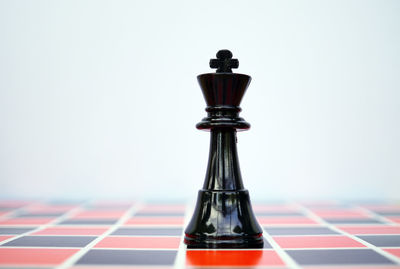 Close-up of chess piece against white background