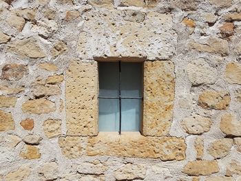 Old rustic vintage window on stone wall