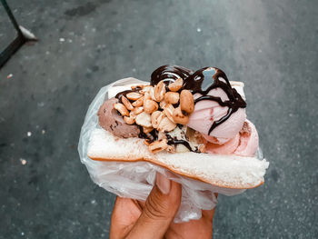 Close-up of hand holding ice cream cone