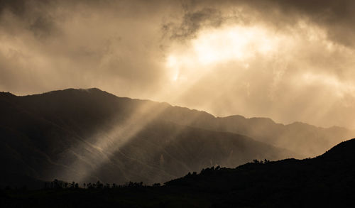 Scenic view of silhouette mountains against sky during sunset