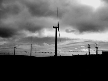 Low angle view of silhouette fence against sky