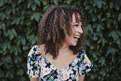 Portrait of smiling young woman looking away outdoors