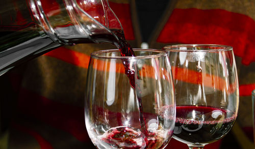 Two glasses with red wine close-up on a dark background