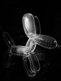 Close-up of illuminated lighting equipment against black background