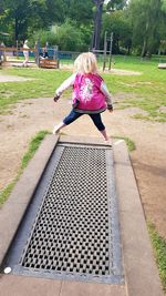 Girl sitting on swing in park