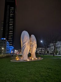 Statue of illuminated building at night