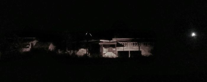 Silhouette built structure at night