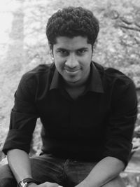 Portrait of young man sitting outdoors