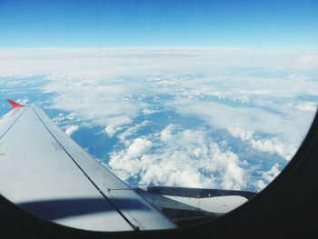 Cropped image of airplane wing over landscape