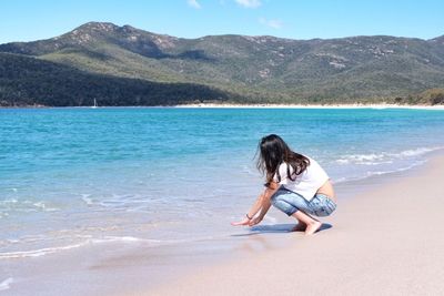 Woman sitting on beach