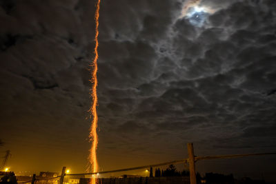 Low angle view of vapor trails against sky at sunset