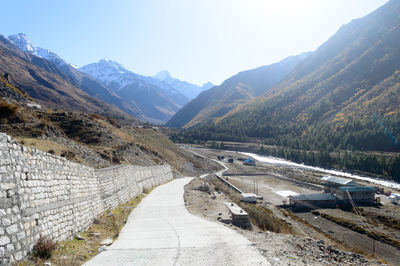 Road amidst mountains against sky