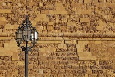 Low angle view of illuminated brick wall