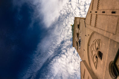 Low angle view of building against cloudy sky