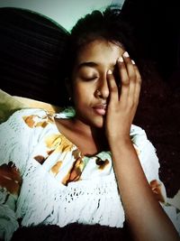 Portrait of young woman sleeping on bed