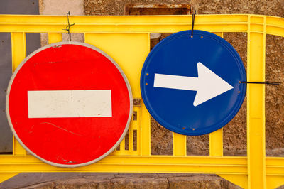 Close-up of arrow sign on road