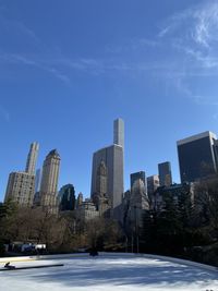 Buildings in city against blue sky