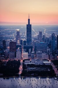 Aerial view of buildings in city during sunset