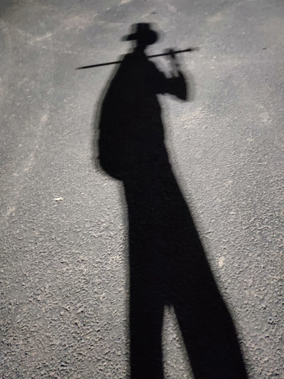 SHADOW OF PERSON ON STREET