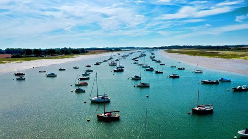 High angle view of sailboats moored on sea against sky