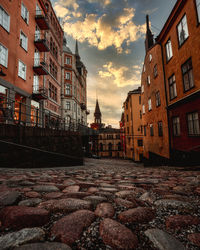 Surface level of street amidst buildings against sky