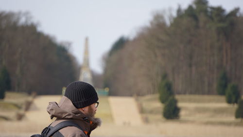 Side view of man wearing warm clothing in park