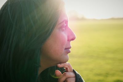 Close-up of thoughtful woman on field