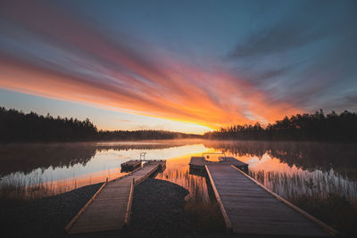 Breathtaking sunrise at lake jatkonjärvi, which is coloured red, orange, purple, pink and blue sun. 
