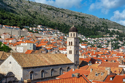 Houses in town against sky