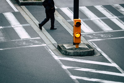 Low section of man walking on city street