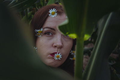 Close-up of young woman with flower