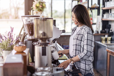 Owner preparing coffee at coffee shop