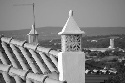 Roof of building by sea against clear sky