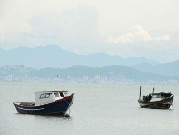 Boats moored in sea