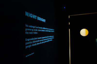 Close-up of illuminated text against black background