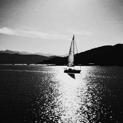 Sailboat sailing on sea against sky