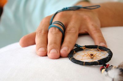 Cropped hand holding dreamcatcher