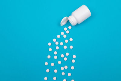 Close-up of colored pencils over blue background