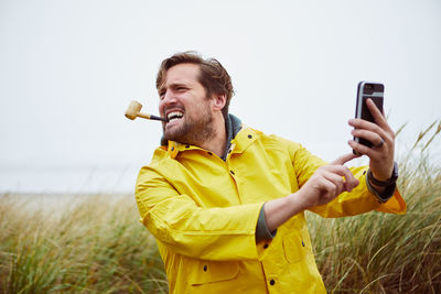 Man taking selfie at beach