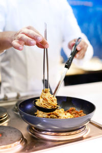 Midsection of man preparing food in kitchen