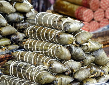 Stack of firewood for sale at market stall