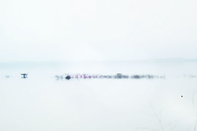 Scenic view of lake against sky during winter