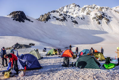 People on snowcapped mountains during winter