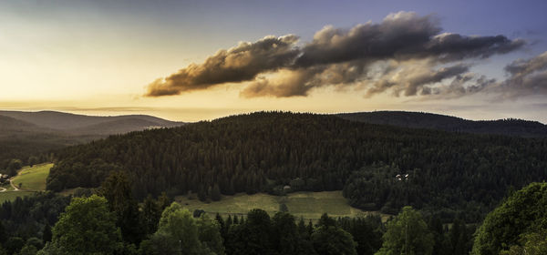 Scenic view of mountains against cloudy sky