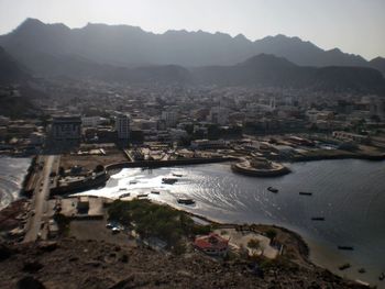 High angle view of townscape and mountains against sky