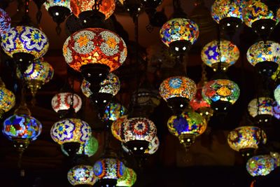 Low angle view of illuminated lanterns hanging at market stall