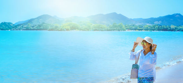 Rear view of woman swimming in sea