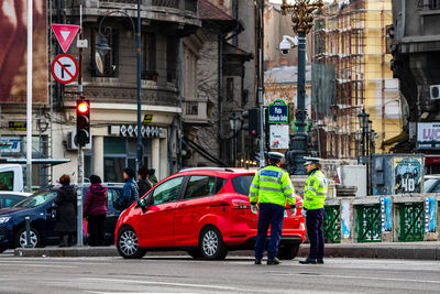 Rear view of people on street in city