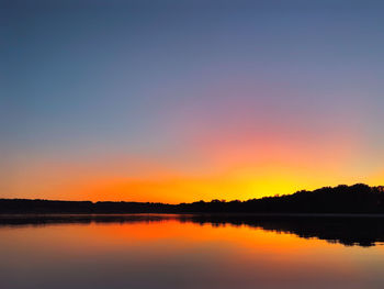 Scenic view of lake against orange sky