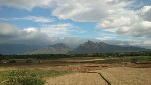 Scenic view of mountains against cloudy sky